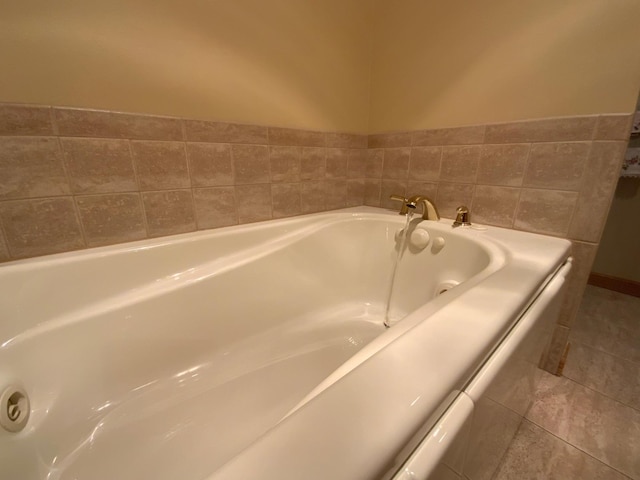 full bathroom with a jetted tub and tile patterned flooring