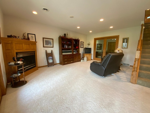 living room with stairway, a fireplace, light colored carpet, recessed lighting, and baseboards