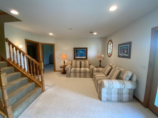 carpeted living area featuring baseboards, stairway, and recessed lighting