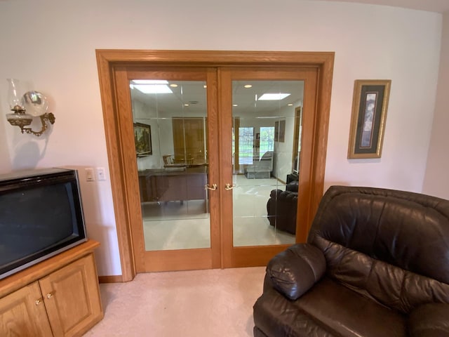 doorway with french doors and light carpet