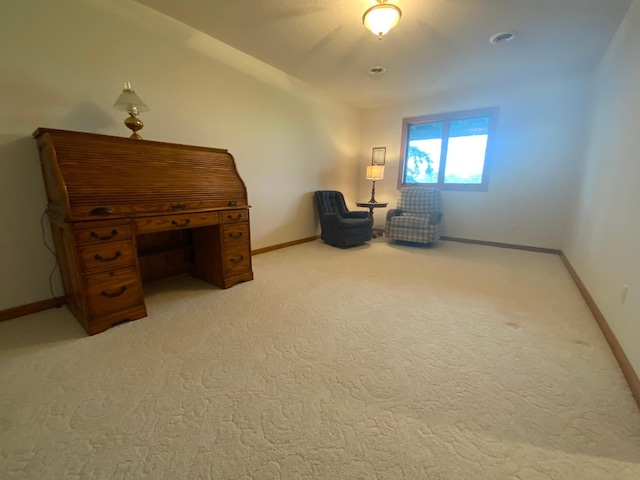 living area with baseboards and light colored carpet