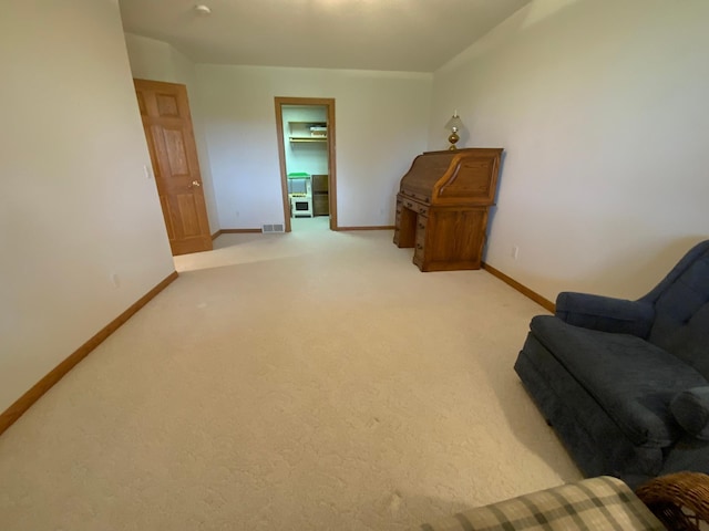 sitting room featuring baseboards and carpet floors
