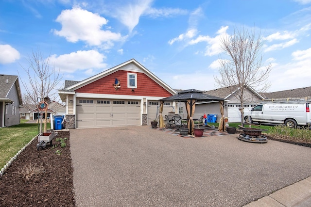 552 Roosevelt St S, Cambridge, MN 55008 - craftsman inspired home with stone siding, a gazebo, a garage, and asphalt driveway