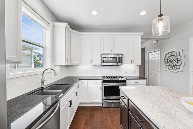 8172 Virginia Ln, Savage, MN 55378 - kitchen with stainless steel appliances, a sink, dark stone counters, white cabinetry, and recessed lighting