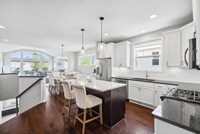 8172 Virginia Ln, Savage, MN 55378 - kitchen featuring appliances with stainless steel finishes, a sink, dark wood finished floors, backsplash, and white cabinetry