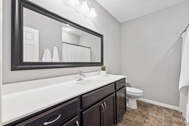 8172 Virginia Ln, Savage, MN 55378 - bathroom with baseboards, vanity, toilet, stone finish flooring, and curtained shower