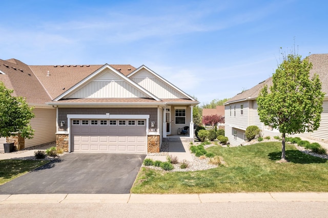 8172 Virginia Ln, Savage, MN 55378 - view of front of home featuring driveway, board and batten siding, stone siding, a garage, and a front yard