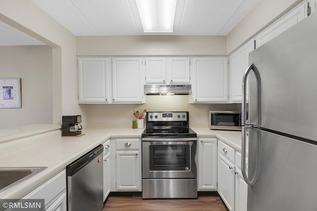 3300 Louisiana Ave S Unit 517, Saint Louis Park, MN 55426 - kitchen featuring stainless steel appliances, dark wood-type flooring, under cabinet range hood, white cabinets, and a textured ceiling