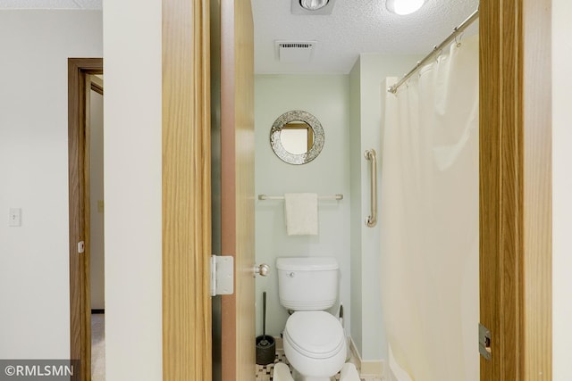 3300 Louisiana Ave S Unit 517, Saint Louis Park, MN 55426 - bathroom featuring a textured ceiling, toilet, and baseboards