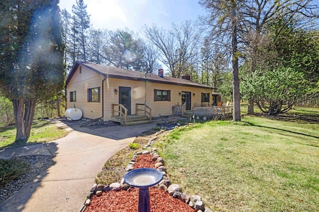 bungalow-style house featuring a chimney and a front yard