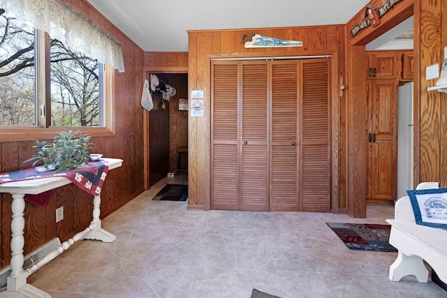 entrance foyer featuring wooden walls