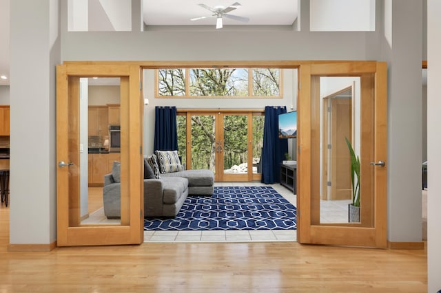 entryway featuring french doors, wood finished floors, and ceiling fan