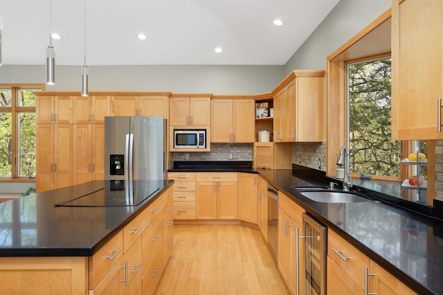 kitchen with stainless steel appliances, a sink, wine cooler, decorative backsplash, and light wood-style floors