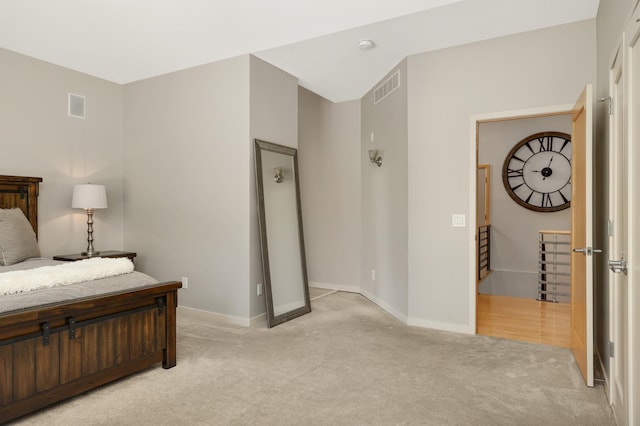 bedroom featuring light colored carpet and baseboards