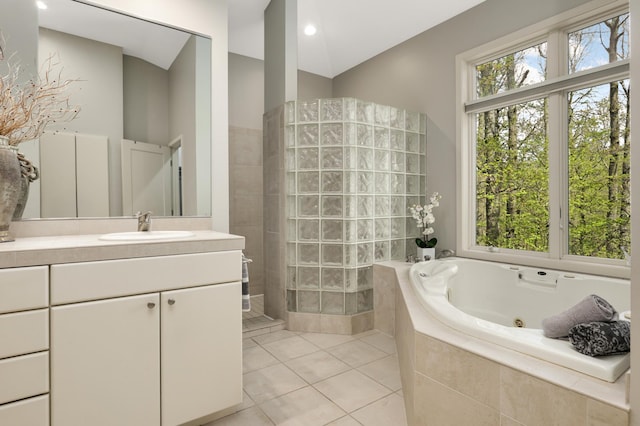 full bathroom featuring plenty of natural light, a tub with jets, tile patterned floors, and walk in shower