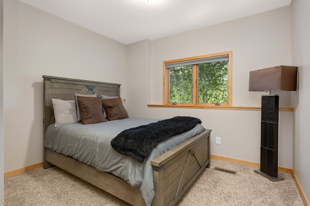 bedroom featuring carpet and baseboards