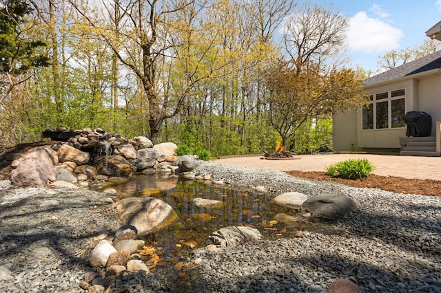 view of yard with a fire pit and a patio area
