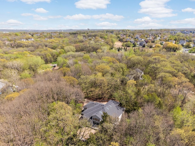 view from above of property featuring a heavily wooded area