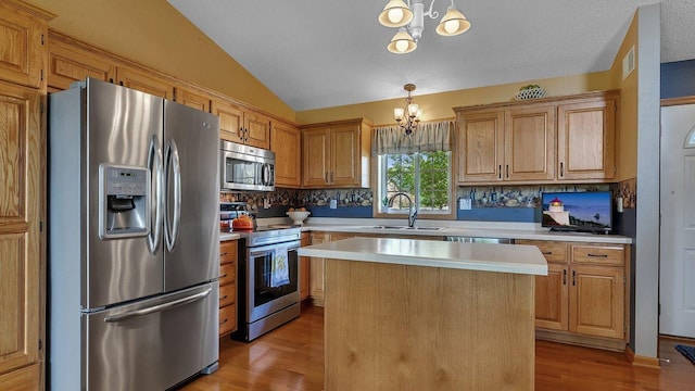 2647 Olive Ln, Sauk Rapids, MN 56379 - kitchen featuring appliances with stainless steel finishes, a chandelier, light countertops, light wood-type flooring, and lofted ceiling