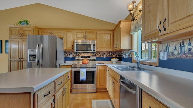 2647 Olive Ln, Sauk Rapids, MN 56379 - kitchen with stainless steel appliances, a sink, vaulted ceiling, light countertops, and light wood finished floors