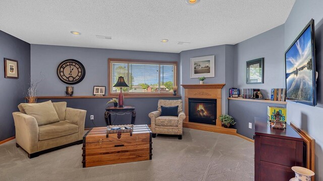 2647 Olive Ln, Sauk Rapids, MN 56379 - sitting room with carpet, a glass covered fireplace, a textured ceiling, recessed lighting, and baseboards