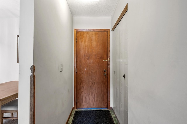 2700 Oxford St N Unit 102, Roseville, MN 55113 - doorway to outside with baseboards and a textured ceiling