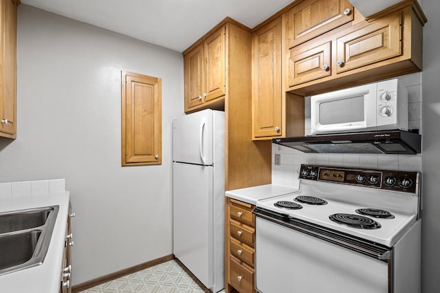 2700 Oxford St N Unit 102, Roseville, MN 55113 - kitchen featuring white appliances, a sink, baseboards, decorative backsplash, and light countertops
