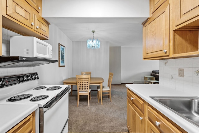 2700 Oxford St N Unit 102, Roseville, MN 55113 - kitchen featuring white appliances, carpet floors, decorative backsplash, a chandelier, and light countertops