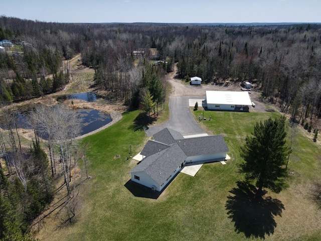 aerial view of property's location featuring a forest