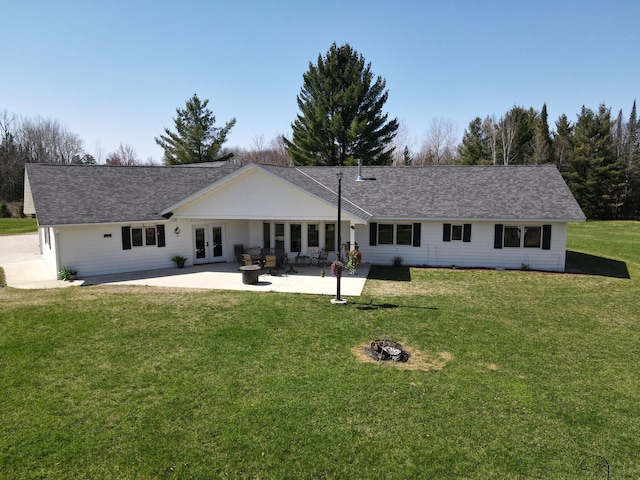 view of front of property with french doors, a patio area, a front yard, a fire pit, and a shingled roof