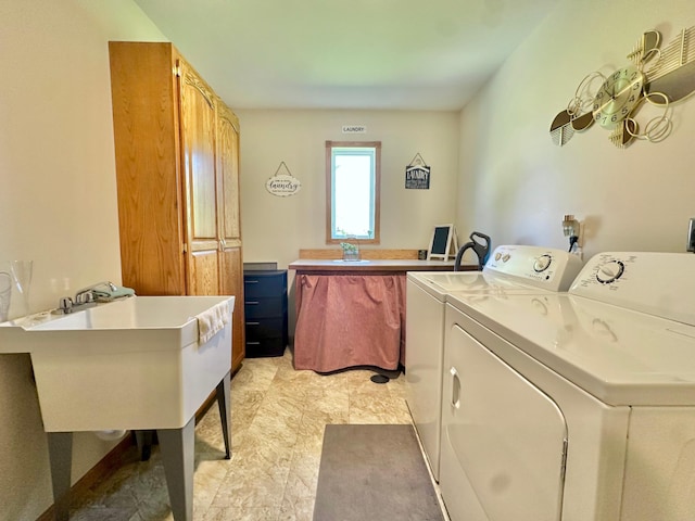 laundry area featuring washing machine and clothes dryer and cabinet space