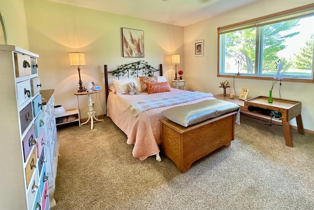 bedroom featuring light carpet and baseboards