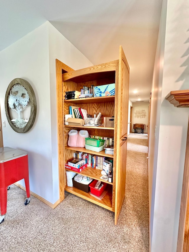 corridor with carpet and baseboards