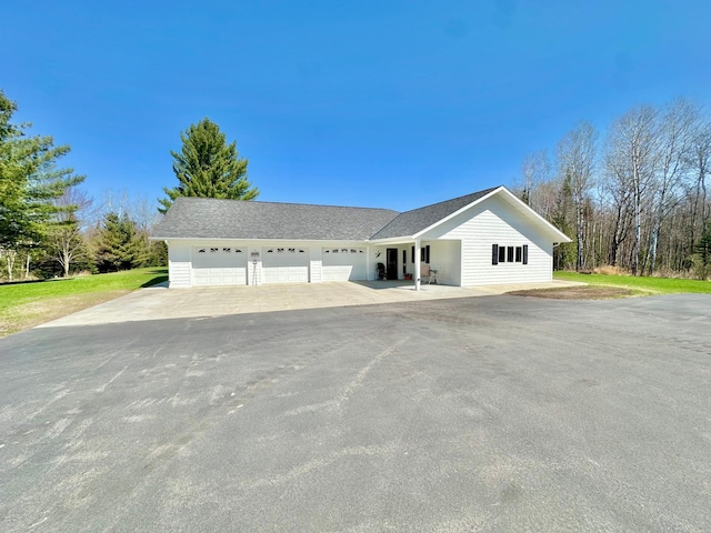 ranch-style house featuring driveway and a garage