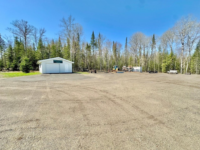 view of yard featuring an outbuilding and a garage