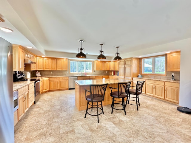 27722 Mallum Dr, Trout Lake Twp, MN 55709 - kitchen featuring appliances with stainless steel finishes, healthy amount of natural light, a sink, and light brown cabinetry
