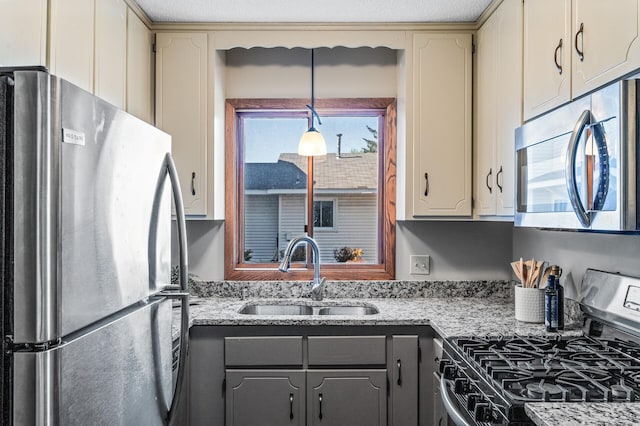11123 Drake St NW, Coon Rapids, MN 55433 - kitchen featuring appliances with stainless steel finishes, a sink, gray cabinets, and light stone counters