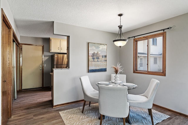 11123 Drake St NW, Coon Rapids, MN 55433 - dining room with dark wood finished floors, baseboards, and a textured ceiling