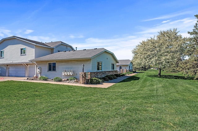 11123 Drake St NW, Coon Rapids, MN 55433 - view of home's exterior with a garage, a yard, concrete driveway, and a shingled roof