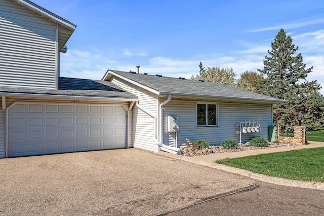 11123 Drake St NW, Coon Rapids, MN 55433 - view of front facade with driveway, an attached garage, and roof with shingles