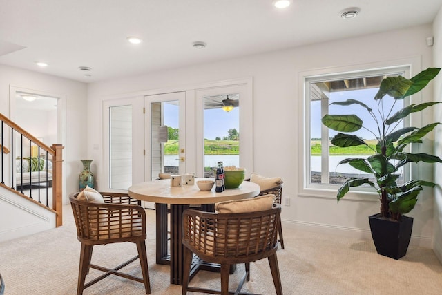 dining space with french doors, light carpet, plenty of natural light, and recessed lighting