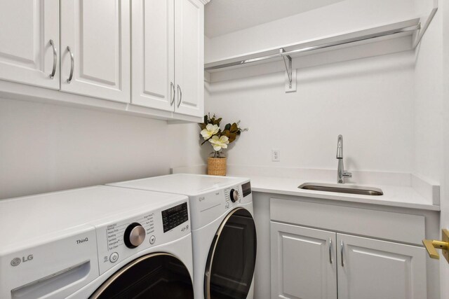 washroom with washer and clothes dryer and cabinet space