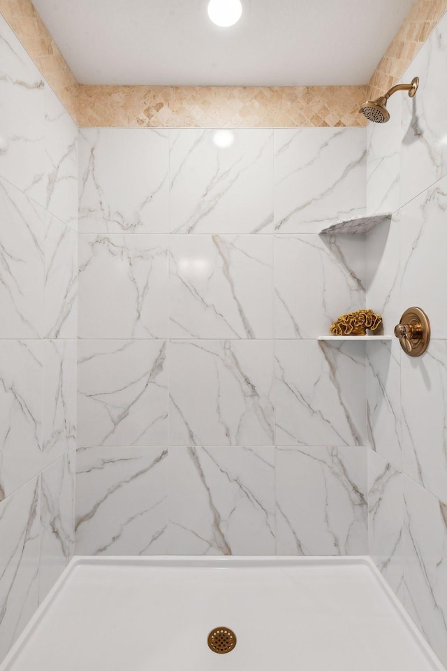 bathroom with a marble finish shower