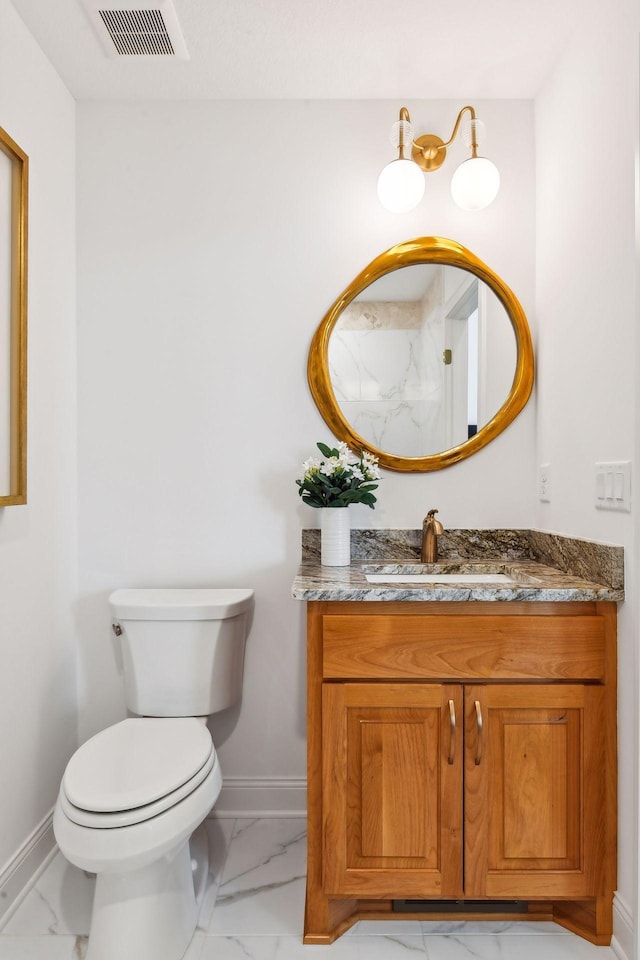 bathroom featuring marble look tiles, baseboards, toilet, and vanity