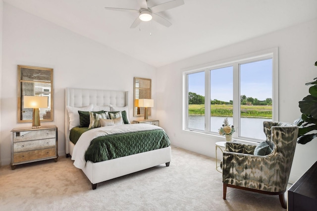 carpeted bedroom featuring vaulted ceiling, a water view, and a ceiling fan