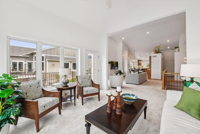 living area with light carpet and recessed lighting
