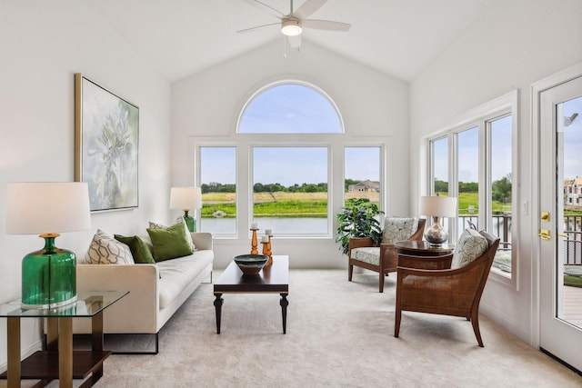 sunroom featuring plenty of natural light, lofted ceiling, and a water view