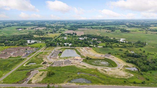 aerial view of property and surrounding area featuring a large body of water and rural landscape