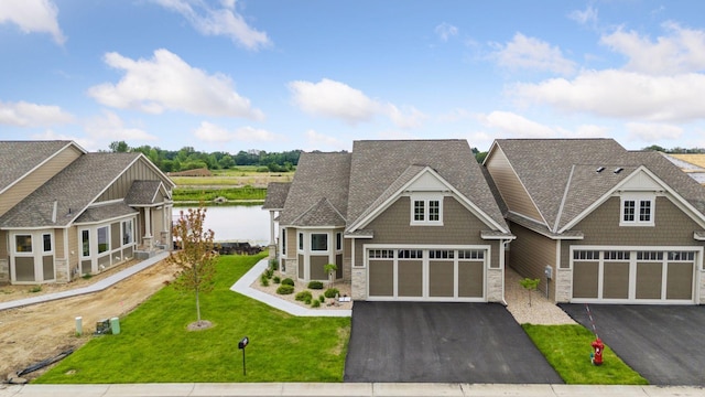 craftsman house featuring stone siding, asphalt driveway, and a front yard