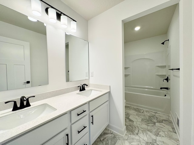 7499 Odell Ave NE, Otsego, MN 55330 - bathroom featuring marble look tile flooring, baseboards, double vanity, bathtub / shower combination, and recessed lighting